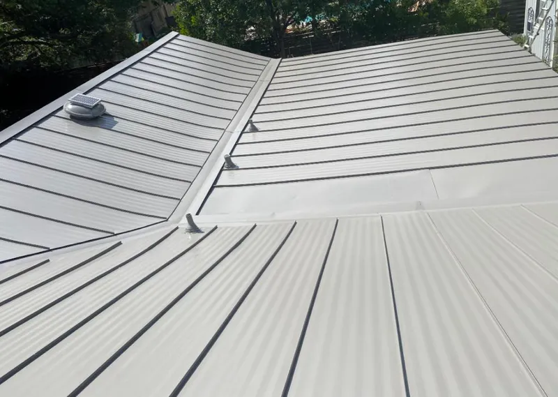 Solar attic fan installed on a metal roof for Roof Ventilation in McNair
